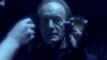 Movie still from “Hellraiser: Hellworld” (2005), directed by Rick Bota – An older man holding a drink in his hand; Close Up shot, Overhead angle