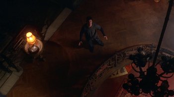 Movie still from “Hellraiser: Hellworld” (2005), directed by Rick Bota – A man standing on the floor of a room; Wide shot, Overhead angle