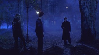 Movie still from “Hellraiser: Hellworld” (2005), directed by Rick Bota – Two people standing in the middle of the night in the dark; Wide shot, Over the shoulder angle