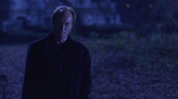 Movie still from “Hellraiser: Hellworld” (2005), directed by Rick Bota – An older man standing in a field at night; Medium shot, Low angle