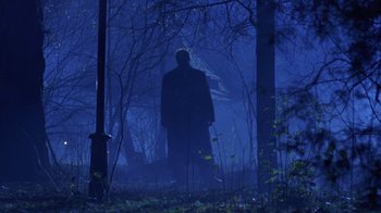 Movie still from “Hellraiser: Hellworld” (2005), directed by Rick Bota – A man standing in the middle of a forest; Wide shot, Low angle