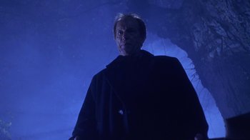 Movie still from “Hellraiser: Hellworld” (2005), directed by Rick Bota – A man standing in the dark in front of a cave; Medium shot, Low angle