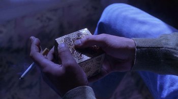 Movie still from “Hellraiser: Hellworld” (2005), directed by Rick Bota – A person holding a box in their hands; Extreme Close Up shot, High angle