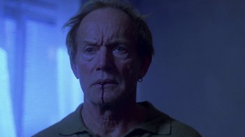 Movie still from “Hellraiser: Hellworld” (2005), directed by Rick Bota – An older man with a knife in his mouth; Close Up shot, Low angle