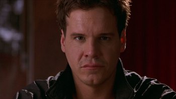 Movie still from “Hellraiser: Inferno” (2000), directed by Scott Derrickson – A person wearing a black jacket; Close Up shot, Over the shoulder angle