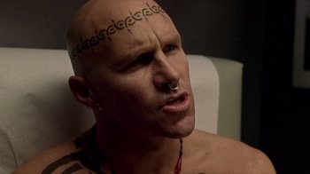 Movie still from “Hellraiser: Inferno” (2000), directed by Scott Derrickson – A man with a tattoo on his head; Close Up shot, Low angle