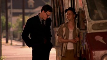 Movie still from “Hellraiser: Inferno” (2000), directed by Scott Derrickson – Two men standing next to each other on the sidewalk; Medium shot, Low angle