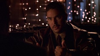 Movie still from “Hellraiser: Inferno” (2000), directed by Scott Derrickson – A man in a leather jacket giving a thumbs up; Close Up shot, Over the shoulder angle