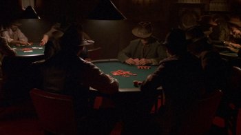 Movie still from “Hellraiser: Inferno” (2000), directed by Scott Derrickson – A group of men playing a game of poker; Wide shot, High angle