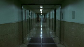 Movie still from “Hellraiser: Inferno” (2000), directed by Scott Derrickson – A hallway with a person walking in it; Extreme Wide shot, High angle