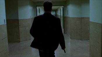 Movie still from “Hellraiser: Inferno” (2000), directed by Scott Derrickson – A man walking down a hall way holding a cane; Wide shot, Over the shoulder angle