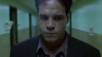 Movie still from “Hellraiser: Inferno” (2000), directed by Scott Derrickson – A person wearing a suit and tie; Close Up shot, Low angle