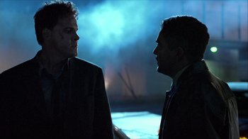 Movie still from “Hellraiser: Inferno” (2000), directed by Scott Derrickson – Two men are talking in the dark; Close Up shot, Over the shoulder angle