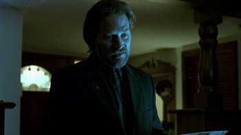 Movie still from “Hellraiser: Inferno” (2000), directed by Scott Derrickson – A man in a black suit and a black tie; Medium shot, Low angle