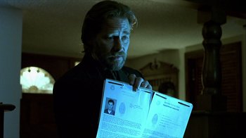 Movie still from “Hellraiser: Inferno” (2000), directed by Scott Derrickson – A man is holding up two papers in front of him; Close Up shot, Low angle