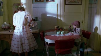 Movie still from “Hellraiser: Inferno” (2000), directed by Scott Derrickson – A woman and a little girl are in a kitchen; Wide shot, High angle