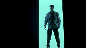 Movie still from “Hellraiser: Inferno” (2000), directed by Scott Derrickson – A man standing in front of a green wall; Medium shot, Low angle