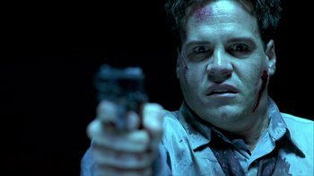 Movie still from “Hellraiser: Inferno” (2000), directed by Scott Derrickson – A man holding a cell phone in his hand; Close Up shot, Low angle