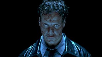 Movie still from “Hellraiser: Inferno” (2000), directed by Scott Derrickson – A person wearing a suit and tie; Close Up shot, Low angle