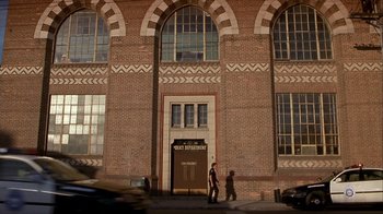 Movie still from “Hellraiser: Inferno” (2000), directed by Scott Derrickson – Two people walking in front of an old building; Extreme Wide shot, Low angle
