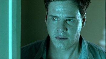 Movie still from “Hellraiser: Inferno” (2000), directed by Scott Derrickson – A person with green eyes; Close Up shot, Over the shoulder angle