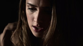 Movie still from “Hellraiser: Judgment” (2018), directed by Gary J. Tunnicliffe – A woman's face in the dark; Close Up shot, Low angle