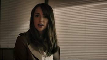 Movie still from “Hellraiser: Judgment” (2018), directed by Gary J. Tunnicliffe – A beautiful young woman with long black hair; Close Up shot, Over the shoulder angle