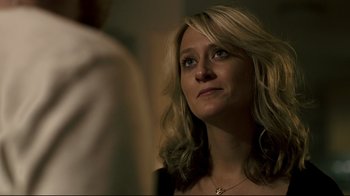 Movie still from “Hellraiser: Judgment” (2018), directed by Gary J. Tunnicliffe – A woman with long blonde hair looking at the camera; Close Up shot, Over the shoulder angle