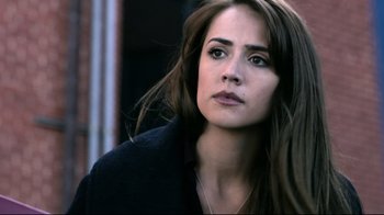 Movie still from “Hellraiser: Judgment” (2018), directed by Gary J. Tunnicliffe – A person with long brown hair; Close Up shot, Over the shoulder angle