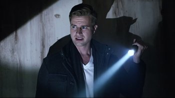 Movie still from “Hellraiser: Judgment” (2018), directed by Gary J. Tunnicliffe – A man holding a flashlight in the dark; Close Up shot, Low angle