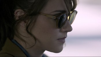 Movie still from “Hellraiser: Judgment” (2018), directed by Gary J. Tunnicliffe – A person wearing sunglasses; Close Up shot, Over the shoulder angle