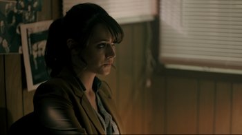 Movie still from “Hellraiser: Judgment” (2018), directed by Gary J. Tunnicliffe – A woman sitting in front of a window; Close Up shot, Over the shoulder angle