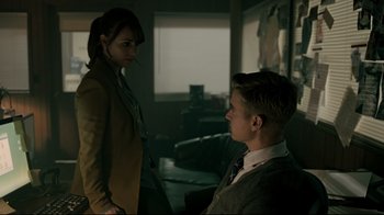 Movie still from “Hellraiser: Judgment” (2018), directed by Gary J. Tunnicliffe – A man and a woman are standing in a living room; Medium shot, Over the shoulder angle