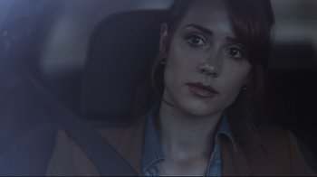 Movie still from “Hellraiser: Judgment” (2018), directed by Gary J. Tunnicliffe – A woman sitting in the back seat of a car; Close Up shot, Over the shoulder angle