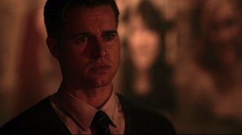 Movie still from “Hellraiser: Judgment” (2018), directed by Gary J. Tunnicliffe – A person wearing a suit and tie; Close Up shot, Over the shoulder angle