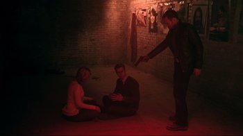 Movie still from “Hellraiser: Judgment” (2018), directed by Gary J. Tunnicliffe – A group of people sitting on the ground in a dark room; Wide shot, High angle
