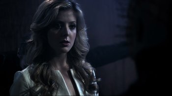 Movie still from “Hellraiser: Judgment” (2018), directed by Gary J. Tunnicliffe – A beautiful woman with long blonde hair wearing a white jacket; Close Up shot, Over the shoulder angle