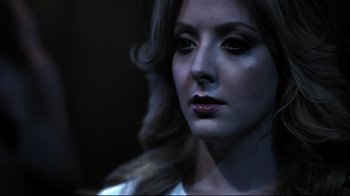 Movie still from “Hellraiser: Judgment” (2018), directed by Gary J. Tunnicliffe – A beautiful woman with long brown hair wearing a white shirt; Close Up shot, Low angle