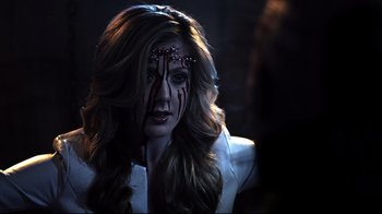 Movie still from “Hellraiser: Judgment” (2018), directed by Gary J. Tunnicliffe – A beautiful woman with long brown hair wearing a white jacket; Close Up shot, Over the shoulder angle
