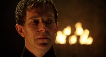 Movie still from “Henry V” (1989), directed by Kenneth Branagh – A person wearing a black shirt; Close Up shot, Over the shoulder angle