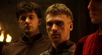 Movie still from “Henry V” (1989), directed by Kenneth Branagh – Two men standing next to each other in front of a wall; Close Up shot, Low angle