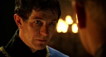 Movie still from “Henry V” (1989), directed by Kenneth Branagh – A person wearing a blue shirt; Close Up shot, Over the shoulder angle