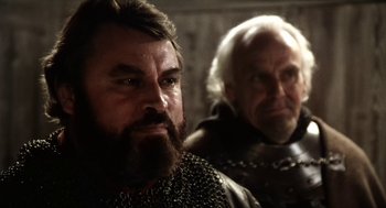 Movie still from “Henry V” (1989), directed by Kenneth Branagh – A man with a long beard and a man with a long beard; Close Up shot, Over the shoulder angle