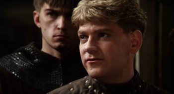 Movie still from “Henry V” (1989), directed by Kenneth Branagh – Two young men are posing for a picture; Close Up shot, Over the shoulder angle