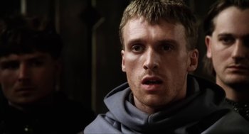 Movie still from “Henry V” (1989), directed by Kenneth Branagh – A person wearing a monk's robe; Close Up shot, Over the shoulder angle