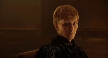 Movie still from “Henry V” (1989), directed by Kenneth Branagh – A man with blonde hair sitting in a chair; Close Up shot, Low angle