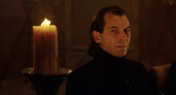 Movie still from “Henry V” (1989), directed by Kenneth Branagh – A man in a black shirt is looking at a candle; Close Up shot, Low angle