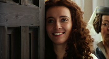 Movie still from “Henry V” (1989), directed by Kenneth Branagh – A person with long red curly hair; Close Up shot, Over the shoulder angle