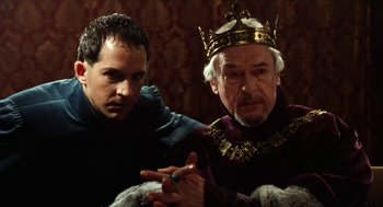 Movie still from “Henry V” (1989), directed by Kenneth Branagh – A man and a man wearing a gold crown; Close Up shot, Over the shoulder angle