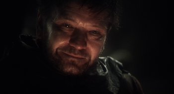 Movie still from “Henry V” (1989), directed by Kenneth Branagh – A person wearing a leather jacket; Close Up shot, Over the shoulder angle